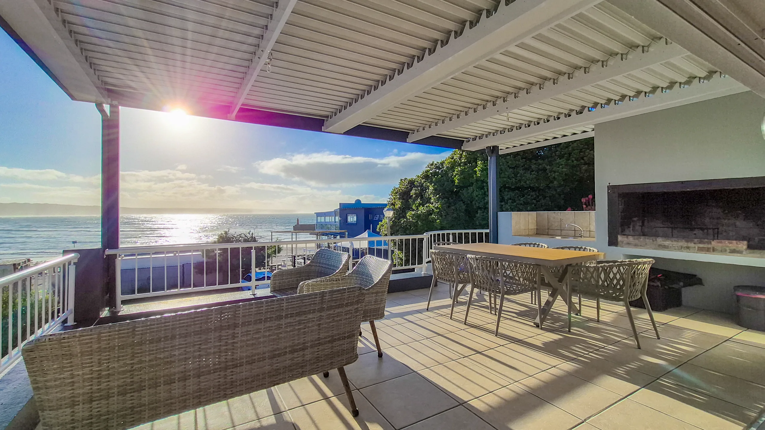 Covered patio and braai area at sunrise, Die Hawehuis