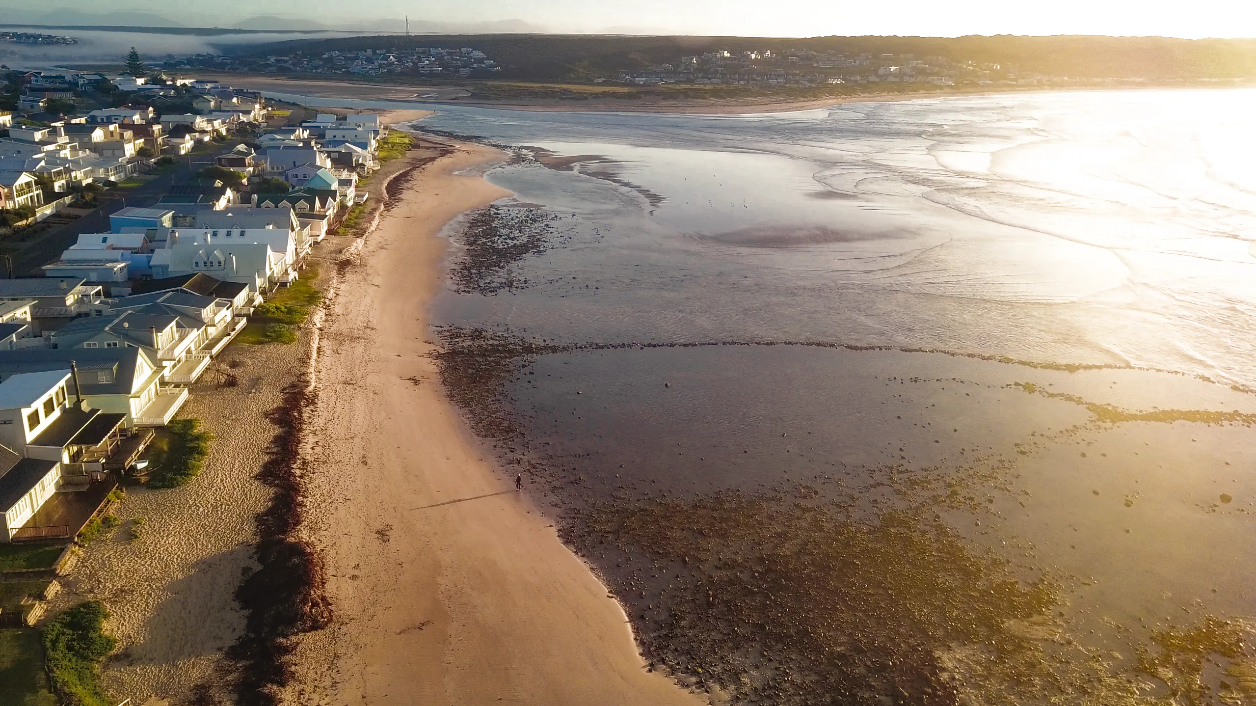 Aerial view of Stilbaai's beach and harbour town at sunrise, Die Hawehuis